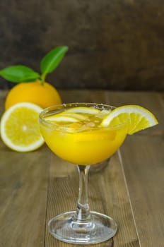 Fresh orange juice on wooden table over grunge background