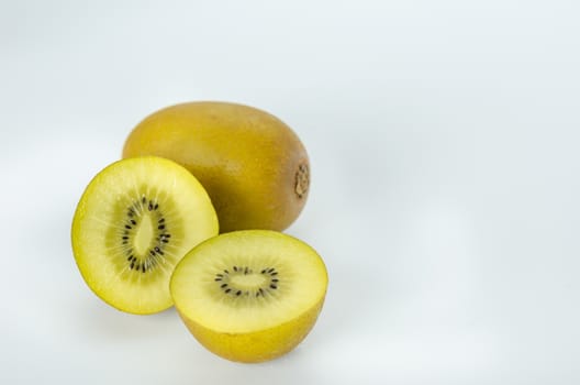 delicious whole kiwi fruit and half on white background