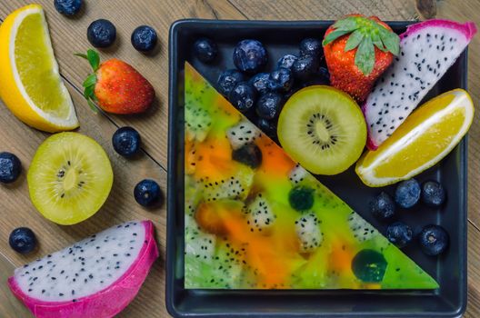 Top view of mixed jelly fruits ( strawberry, blueberry, kiwi, orange, dragon fruit )