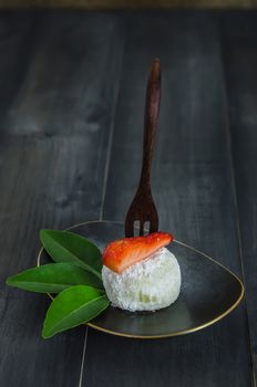 Strawberry Daifuku Mochi Japanese dessert on dish over wooden background , still life