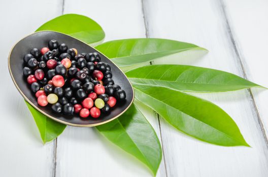 Thai Blueberry in white bowl over wooden background , still life