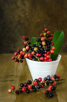 Thai Blueberry in white bowl over wooden background , still life