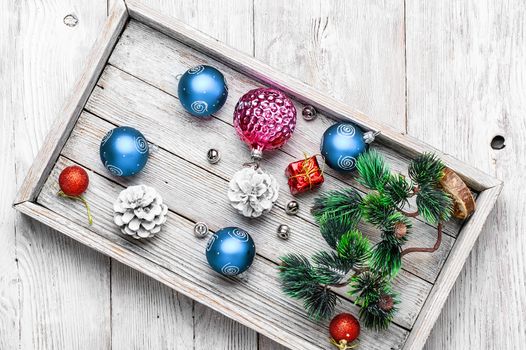 Wooden box with Christmas decorations and the tree