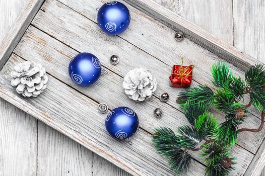 Wooden box with Christmas decorations and the tree