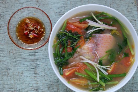 Vietnamese food, fish soup from tomato, onion, celery and red tiapia. Is popular daily dish that nutrition and good for health
