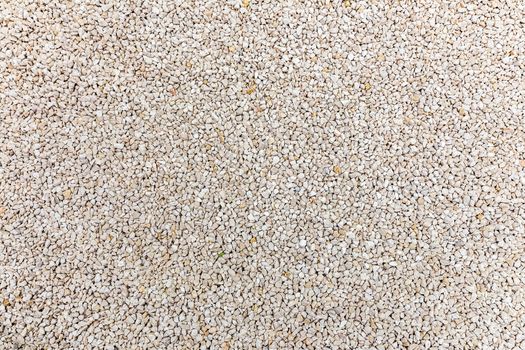 Lot of small grey gravel stones at beach as background