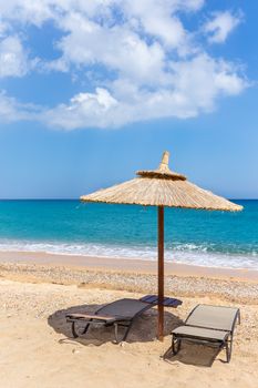 One  parasol and sun beds and parasol at sea