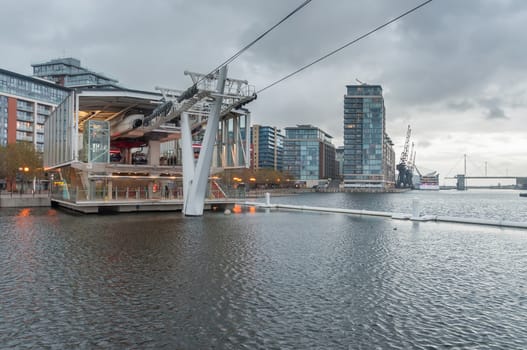 LONDON, UNITED KINGDOM - NOVEMBER 8, 2014: Royal Victoria Docks cable car station on a rainy day. Emirates Air Line is a ten minute gondola lift link across the River Thames.