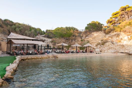 Cameo Island, Zakynthos, Greece - August 26, 2015: Tourists visit beach bar on Cameo Island - the most popular Zante wedding locations in the Greek islands.