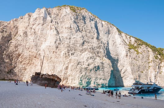 Zakynthos, Greece - August 27, 2015: Tourists at the Navagio Beach and view of Shipwreck on Zakynthos Island. Famous Navagio Beach is the most popular tourist attraction on the island.