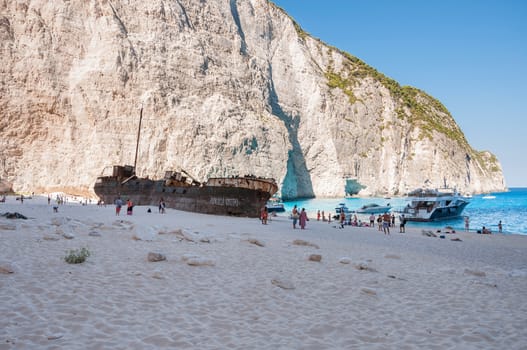 Zakynthos, Greece - August 27, 2015: Tourists at the Navagio Beach and view of Shipwreck on Zakynthos Island. Famous Navagio Beach is the most popular tourist attraction on the island.