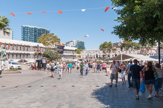 Gibraltar, United Kingdom - August 27, 2014: Tourists visit Grand Casemates Square. The square is lined with numerous pubs, bars and restaurants and acts as the gateway into Gibraltar's city centre.