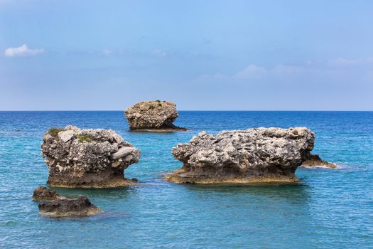 Three separate rocks offshore in blue greek ocean