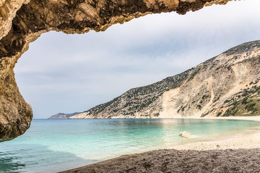 Cave outlook on cove with  sea mountain and gravel beach