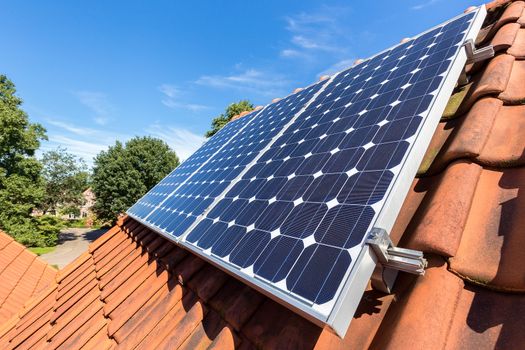 Row of blue solar panels  on orange roof