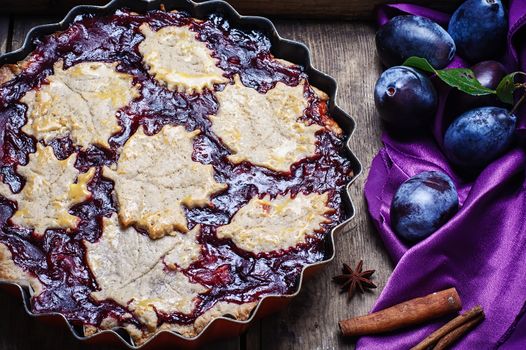 Autumn pie with plum decorated cakes in the form of leaflets