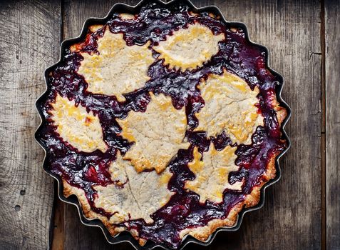 Autumn pie with plum decorated cakes in the form of leaflets