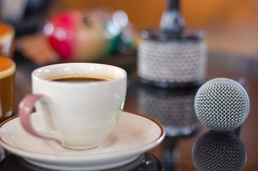 Cup of hot coffee in music  on black  background