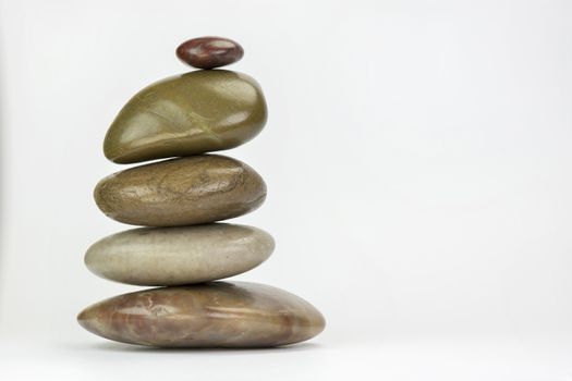 Pile of colourful boulders of natural stone on a white background
