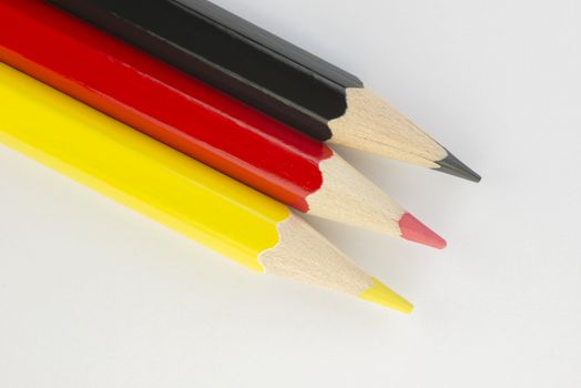 Collection of colorful pencils in German flag colors black, red and yellow as a background picture
