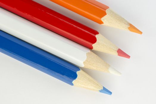Collection of colorful pencils in Dutch flag colors orange red white and blue as a background picture
