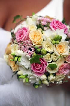 The bride holds a wedding bouquet