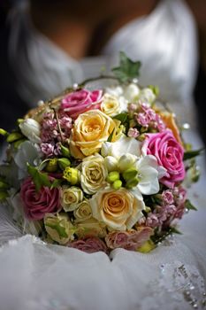 The bride holds a wedding bouquet