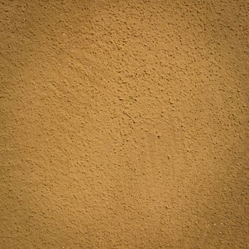 Mustard wall background and texture with vignetting and blank copyspace for text or advertising.