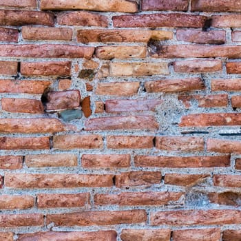 Detailed ancient red brick wall background photo texture.