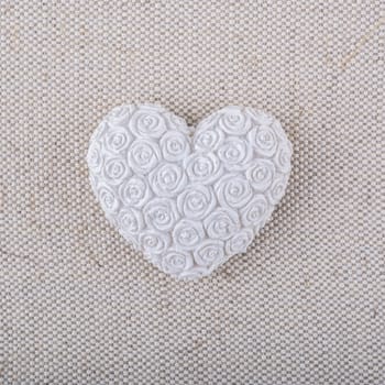 White heart on a beige fabric