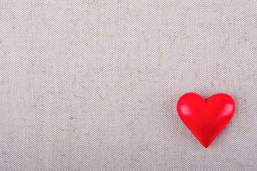 Red heart on a beige fabric