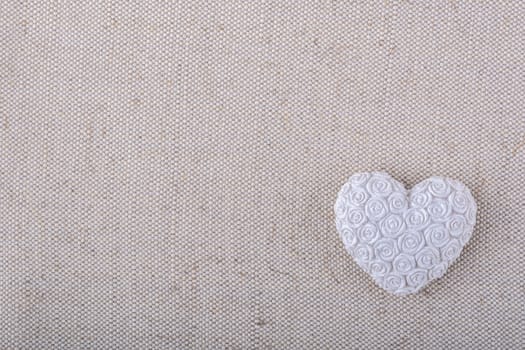 White heart on a beige fabric