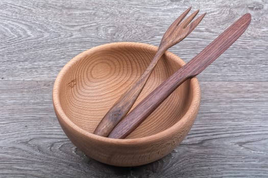 Wooden cutlery on a grey wooden background background