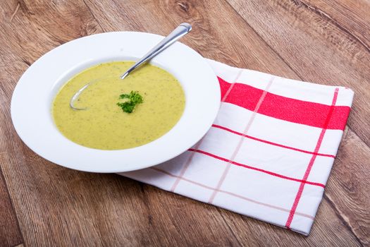 Cream of broccoli soup on a white plate