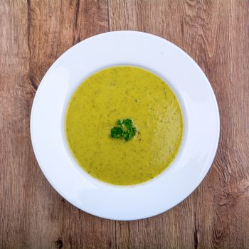 Cream of broccoli soup on a white plate