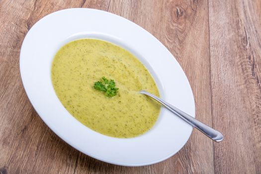 Cream of broccoli soup on a white plate