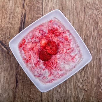 Strawberry puree, decorated with fresh strawberries