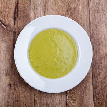 Vegetable split pea soup on a brown wooden background