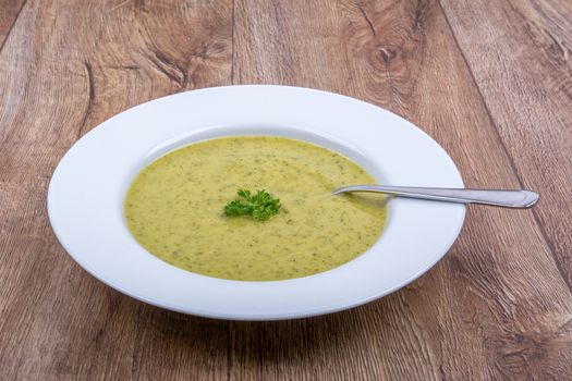 Cream of broccoli soup on a white plate