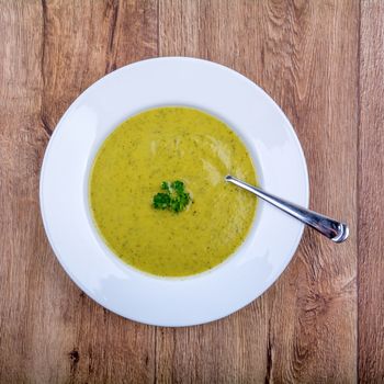 Cream of broccoli soup on a white plate