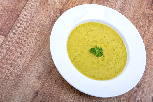 Cream of broccoli soup on a white plate