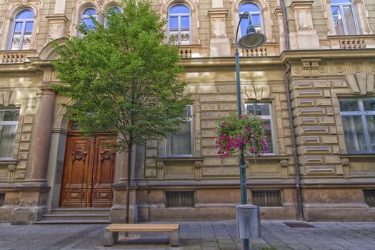 street scene with an old building and a bench