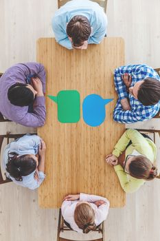 Businessteam working at meeting table with paper dialog boxes on it