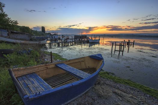 old boat on the beach at the sunset