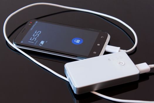 Smartphone is charging with power bank while it standby