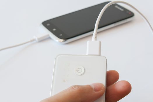 Smartphone is charging with power bank while it standby