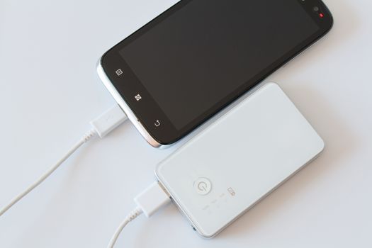 Smartphone is charging with power bank while it standby