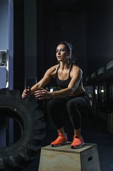 Concept: power, strength, healthy lifestyle, sport. Powerful attractive muscular woman CrossFit trainer do jumps during workout at the gym