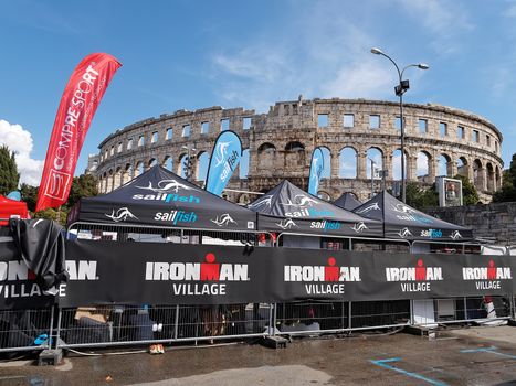 PULA, CROATIA - SEPTEMBER 17, 2016 - Ironman village open stores in front of amphitheater in Pula, Croatia on September 17, 2016.