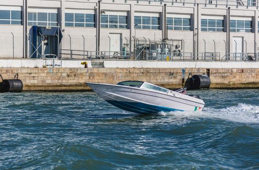motor boat is floating along the coast